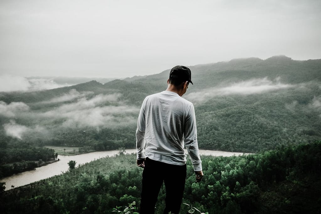 Man enjoying on scenic view from a cliff